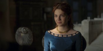 Movie still from “House of the Dragon” (2022), created by George R.R. Martin – A woman in a blue dress and a gold necklace; Close Up shot, Over the shoulder angle