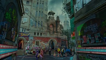 Movie still from “The Zero Theorem” (2013), directed by Terry Gilliam – A group of people walking down a street near a building; Extreme Wide shot, Low angle