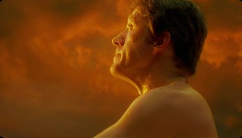 Movie still from “The Zero Theorem” (2013), directed by Terry Gilliam – A man with his head turned to the side; Close Up shot, Low angle