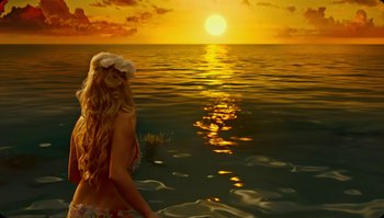 Movie still from “The Zero Theorem” (2013), directed by Terry Gilliam – A woman standing in the ocean at sunset; Wide shot, High angle