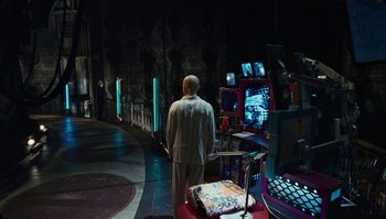 Movie still from “The Zero Theorem” (2013), directed by Terry Gilliam – A man standing in front of a computer screen; Wide shot, High angle