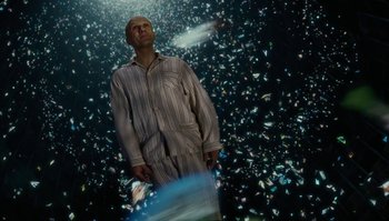 Movie still from “The Zero Theorem” (2013), directed by Terry Gilliam – A man standing in front of a wall of mirrors; Medium shot, Low angle