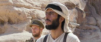 A man with a beard wearing a hat and a uniform