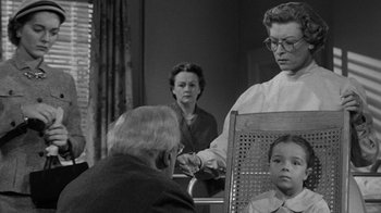 Movie still from “Them!” (1954), directed by Gordon Douglas – An older man and a young woman in front of an older woman; Medium shot, Over the shoulder angle
