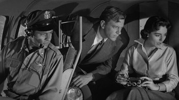 Movie still from “Them!” (1954), directed by Gordon Douglas – Three men sitting in the back of a car; Medium shot, Low angle