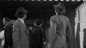 Movie still from “Them!” (1954), directed by Gordon Douglas – A black and white photo of two men wearing hats; Medium shot, Low angle