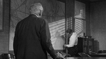 Movie still from “Them!” (1954), directed by Gordon Douglas – Two men in suits and ties in a room; Medium shot, Over the shoulder angle