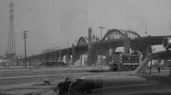 Movie still from “Them!” (1954), directed by Gordon Douglas – An old black and white photo of a bridge construction site; Extreme Wide shot, High angle