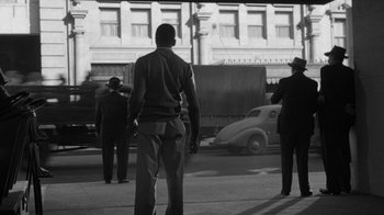 Movie still from “Them!” (1954), directed by Gordon Douglas – Black and white photograph of men on a city street; Wide shot, Low angle