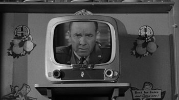 Movie still from “Them!” (1954), directed by Gordon Douglas – An old tv with a picture of a man in a uniform; Close Up shot, Over the shoulder angle