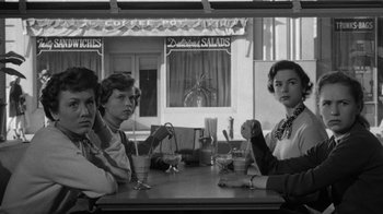 Movie still from “Them!” (1954), directed by Gordon Douglas – A group of people sitting at a table in a restaurant; Medium shot, High angle