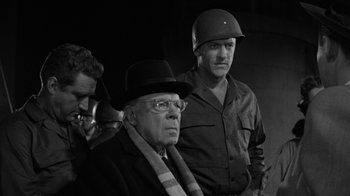 Movie still from “Them!” (1954), directed by Gordon Douglas – A man in a hat and glasses and a man in a hat and glasses and a man in a hat and glasses; Medium shot, Over the shoulder angle
