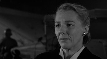 Movie still from “Them!” (1954), directed by Gordon Douglas – An older woman is looking into the distance; Close Up shot, Low angle