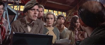 Movie still from “They Shoot Horses, Don't They?” (1969), directed by Sydney Pollack – A group of people standing in front of a window; Medium shot, Low angle