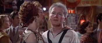 Movie still from “They Shoot Horses, Don't They?” (1969), directed by Sydney Pollack – An older man and a younger woman are standing together; Close Up shot, Low angle