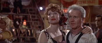 Movie still from “They Shoot Horses, Don't They?” (1969), directed by Sydney Pollack – A person wearing a dress with a flower in her hair; Close Up shot, Low angle