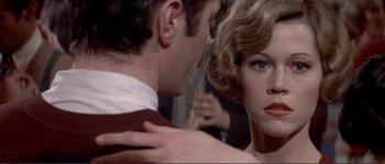 Movie still from “They Shoot Horses, Don't They?” (1969), directed by Sydney Pollack – A man and a woman are looking at each other; Close Up shot, Over the shoulder angle