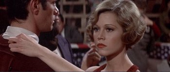 Movie still from “They Shoot Horses, Don't They?” (1969), directed by Sydney Pollack – A man and a woman looking at one another; Close Up shot, Over the shoulder angle