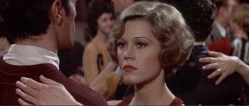 Movie still from “They Shoot Horses, Don't They?” (1969), directed by Sydney Pollack – A person wearing a red dress; Close Up shot, Over the shoulder angle