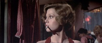 Movie still from “They Shoot Horses, Don't They?” (1969), directed by Sydney Pollack – A woman smoking a cigarette while wearing a red dress; Close Up shot, Low angle