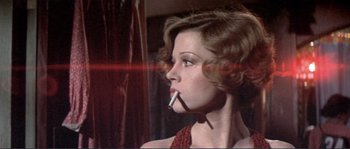 Movie still from “They Shoot Horses, Don't They?” (1969), directed by Sydney Pollack – A young woman smoking a cigarette while wearing a red dress; Close Up shot, Low angle