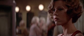 Movie still from “They Shoot Horses, Don't They?” (1969), directed by Sydney Pollack – A person wearing a white shirt; Close Up shot, Over the shoulder angle