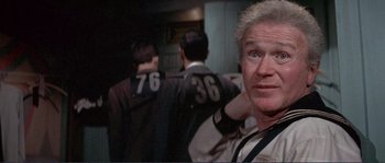 Movie still from “They Shoot Horses, Don't They?” (1969), directed by Sydney Pollack – A person with a number on their shirt; Close Up shot, Low angle