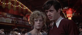 Movie still from “They Shoot Horses, Don't They?” (1969), directed by Sydney Pollack – A man and a woman standing next to each other; Close Up shot, Low angle