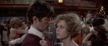 Movie still from “They Shoot Horses, Don't They?” (1969), directed by Sydney Pollack – A man and a woman standing next to each other; Close Up shot, Over the shoulder angle