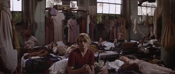Movie still from “They Shoot Horses, Don't They?” (1969), directed by Sydney Pollack – A group of people laying on the floor in a room; Wide shot, High angle
