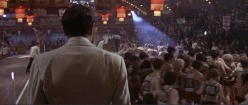 Movie still from “They Shoot Horses, Don't They?” (1969), directed by Sydney Pollack – A crowd of people in a room with lights on; Wide shot, Over the shoulder angle