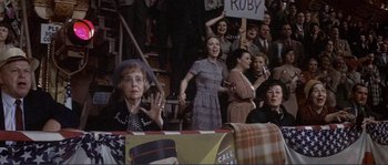 Movie still from “They Shoot Horses, Don't They?” (1969), directed by Sydney Pollack – A group of people that are sitting in the stands; Medium shot, High angle
