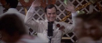 Movie still from “They Shoot Horses, Don't They?” (1969), directed by Sydney Pollack – A man that is holding a microphone; Medium shot, High angle