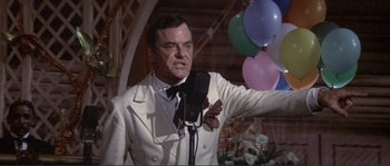 Movie still from “They Shoot Horses, Don't They?” (1969), directed by Sydney Pollack – A man in a white suit and bow tie; Medium shot, Low angle