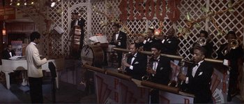 Movie still from “They Shoot Horses, Don't They?” (1969), directed by Sydney Pollack – A group of men in tuxedos playing musical instruments; Wide shot, High angle
