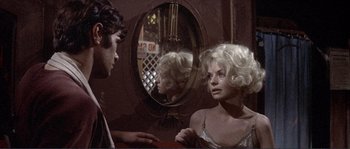 Movie still from “They Shoot Horses, Don't They?” (1969), directed by Sydney Pollack – A man and a woman looking at each other in a mirror; Close Up shot, Over the shoulder angle
