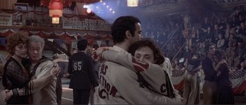 Movie still from “They Shoot Horses, Don't They?” (1969), directed by Sydney Pollack – A man and a woman hugging each other in front of an audience; Medium shot, Over the shoulder angle