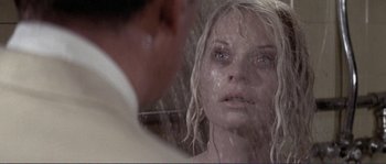 Movie still from “They Shoot Horses, Don't They?” (1969), directed by Sydney Pollack – A woman with wet hair looking into a mirror; Close Up shot, Over the shoulder angle