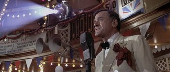 Movie still from “They Shoot Horses, Don't They?” (1969), directed by Sydney Pollack – An older man in a white shirt and a bow tie; Medium shot, Low angle