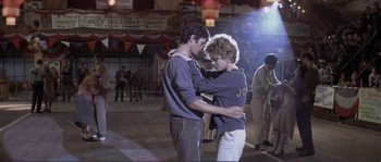 Movie still from “They Shoot Horses, Don't They?” (1969), directed by Sydney Pollack – A man and a woman are dancing in a dance studio; Wide shot, Low angle
