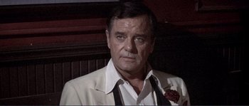 Movie still from “They Shoot Horses, Don't They?” (1969), directed by Sydney Pollack – A person wearing a suit and tie; Close Up shot, Over the shoulder angle