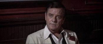 Movie still from “They Shoot Horses, Don't They?” (1969), directed by Sydney Pollack – A person wearing a suit and tie; Close Up shot, Low angle