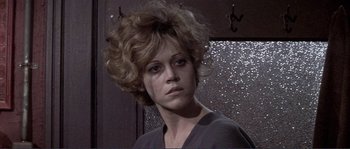 Movie still from “They Shoot Horses, Don't They?” (1969), directed by Sydney Pollack – A person wearing a gray shirt; Close Up shot, Low angle