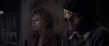 Movie still from “They Shoot Horses, Don't They?” (1969), directed by Sydney Pollack – A man and a woman sitting next to each other in a room; Close Up shot, Over the shoulder angle