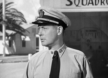 Movie still from “They Were Expendable” (1945), directed by Robert Montgomery – A man wearing a hat and a tie; Medium shot, Low angle
