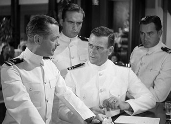 Movie still from “They Were Expendable” (1945), directed by Robert Montgomery – A black and white photo of a group of men in uniform; Medium shot, Over the shoulder angle