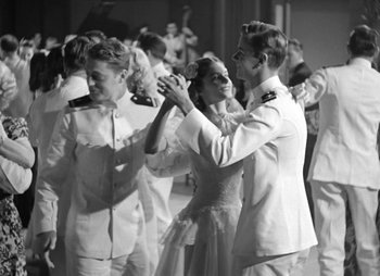 Movie still from “They Were Expendable” (1945), directed by Robert Montgomery – A black - and - white photo of a couple dancing; Medium shot, Low angle