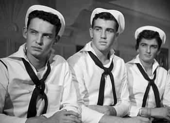 Movie still from “They Were Expendable” (1945), directed by Robert Montgomery – A black and white photo of a group of young men in sailor's uniforms; Medium shot, Low angle