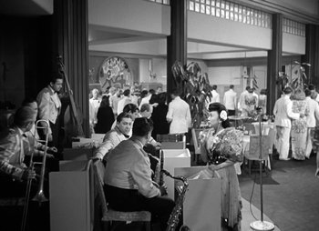 Movie still from “They Were Expendable” (1945), directed by Robert Montgomery – A black and white photo of people in a room; Extreme Wide shot, High angle
