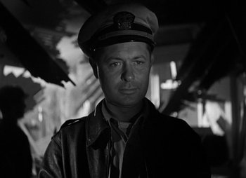 Movie still from “They Were Expendable” (1945), directed by Robert Montgomery – Black and white photograph of a man wearing a hat; Close Up shot, Low angle